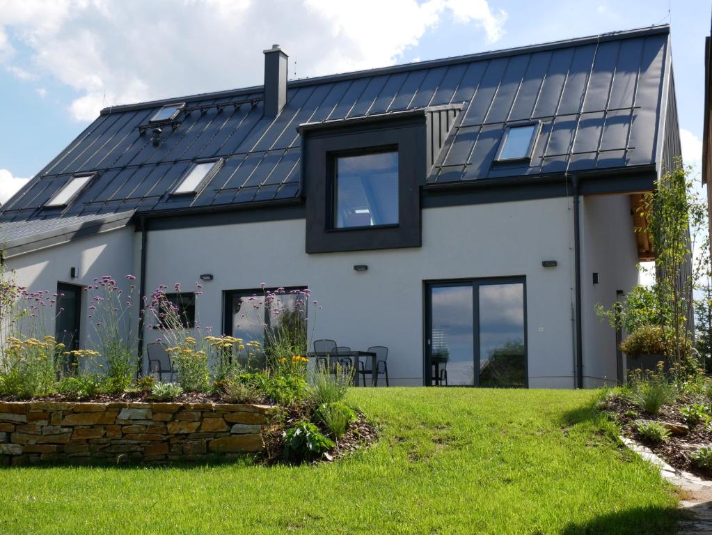 a house with solar panels on the roof at Apartmán Sychrova in Žďár nad Sázavou