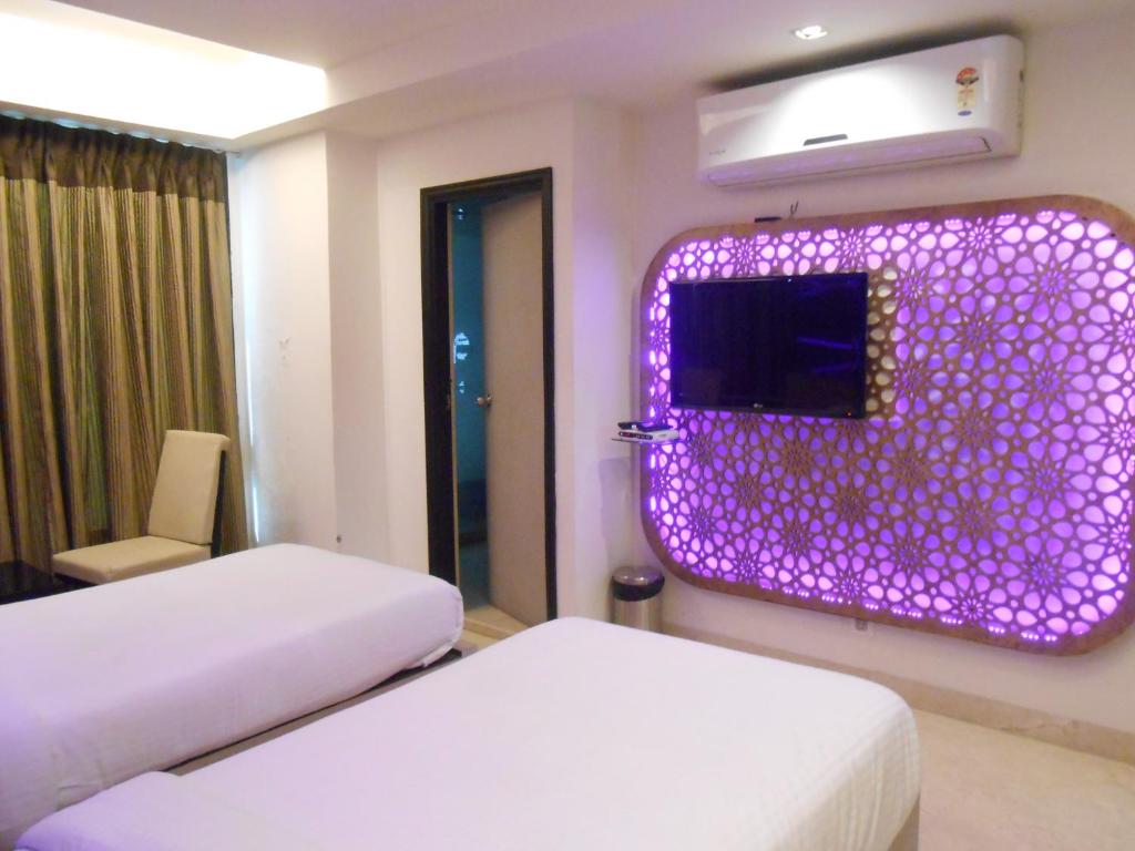 Postel nebo postele na pokoji v ubytování Hotel Aston International