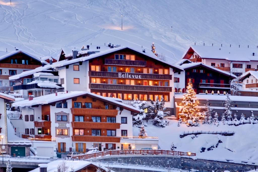 ein Hotel mit einem Weihnachtsbaum im Schnee in der Unterkunft Hotel & Chalet Bellevue in Lech am Arlberg