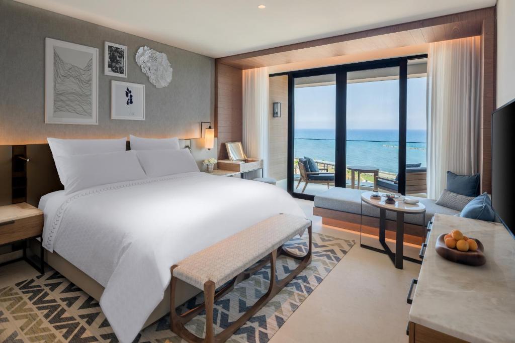 a bedroom with a bed and a view of the ocean at Amara - Sea Your Only View™ in Limassol