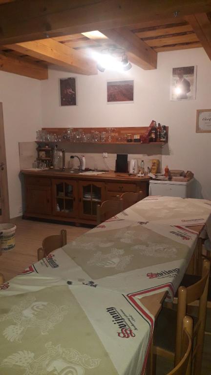 a kitchen with two tables and a counter top at apartman u\Kapra in Jeřmanice