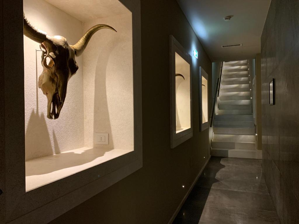 a room with a skull on the wall and a staircase at Neko Boutique Hotel in Cagliari