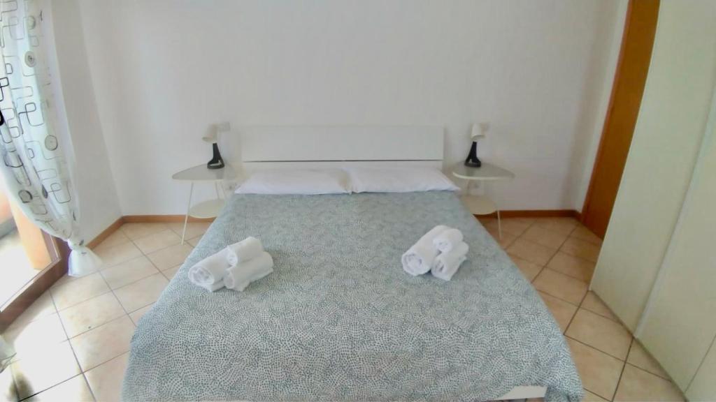 a bedroom with a bed with two towels on it at Residenza Cleopatra 4 in Falconara Marittima