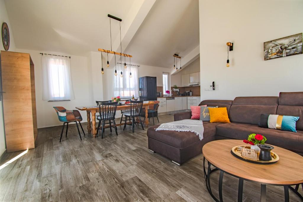 a living room with a couch and a table at OLEA Apartments Vir in Vir