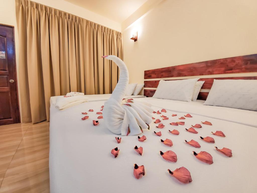 a swan made out of roses on a bed at Shoreline Grand in Thoddoo