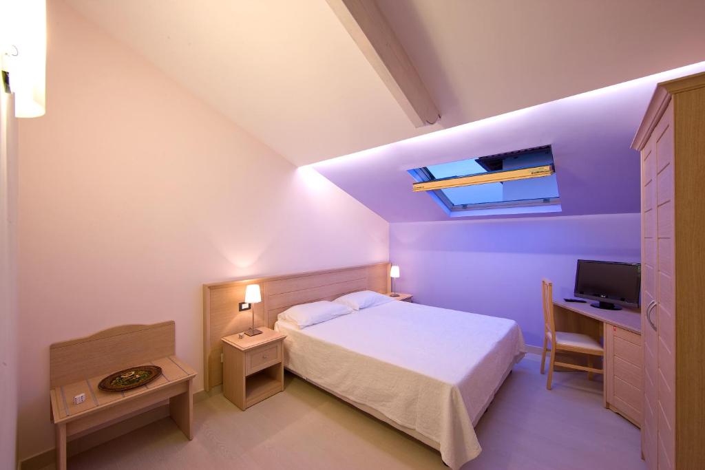 Postel nebo postele na pokoji v ubytování Sorrento Belvedere B&B
