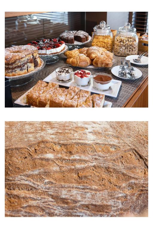 a table with various pastries and cakes and other desserts at Hotel Salus in Pescara