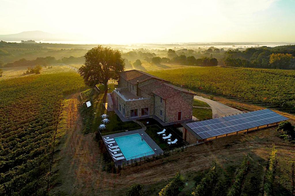 an aerial view of a house with a swimming pool at Podere La Doccia in Civitella in Val di Chiana