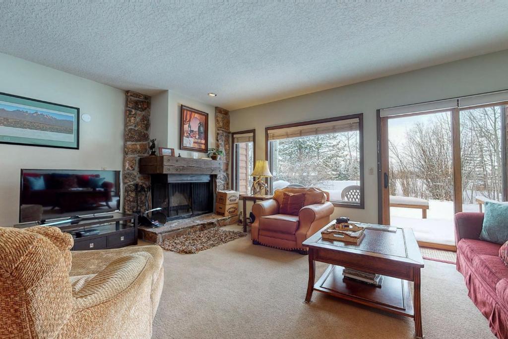 a living room with a couch and a fireplace at Darwin E in Jackson