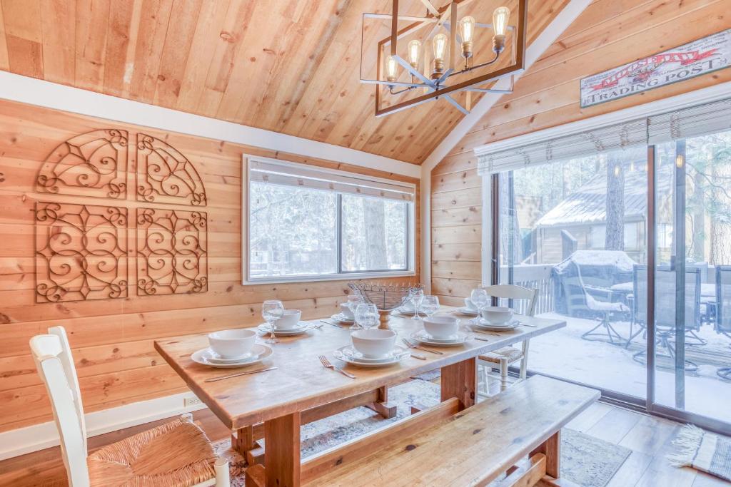 a wooden dining room with a table and a chandelier at Pole House 15 - Meredith Lodging in Sunriver