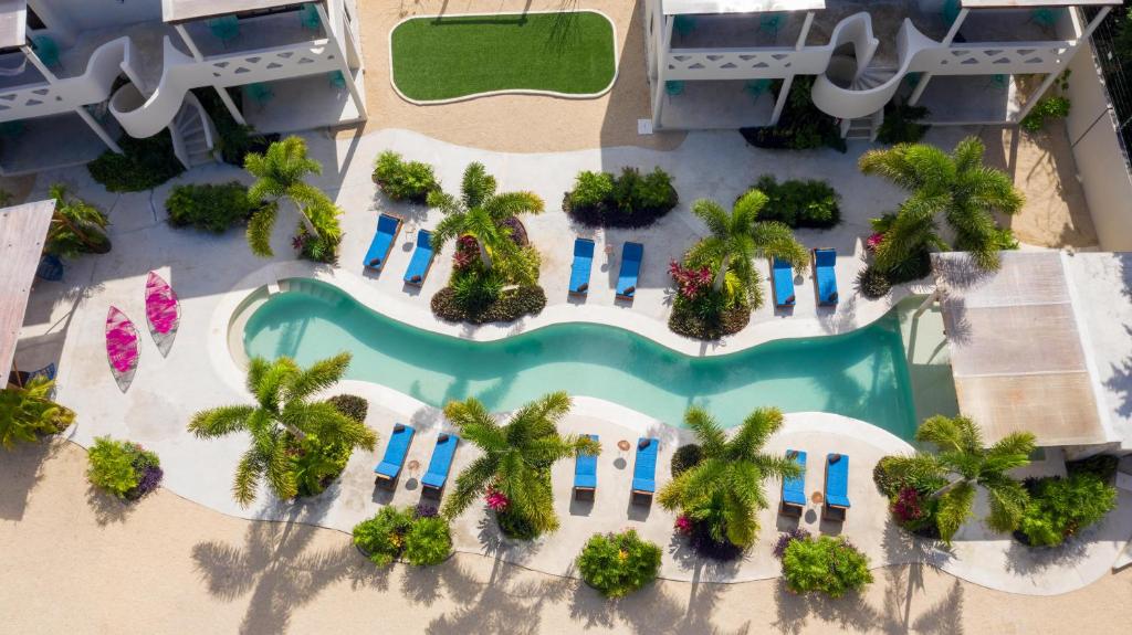 an aerial view of a resort with a pool and palm trees at Blue Palm Bacalar in Bacalar