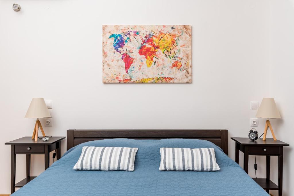 a bedroom with a blue bed with two night stands at La Maison de Penelope in Límnai