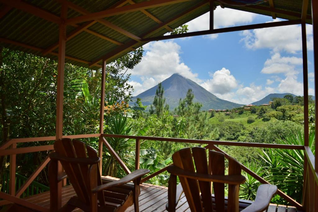 two chairs on a porch with a view of a mountain at Casa Mirador Private and Cozy house Walking distance from Restaurants and Attractions in El Castillo de la Fortuna