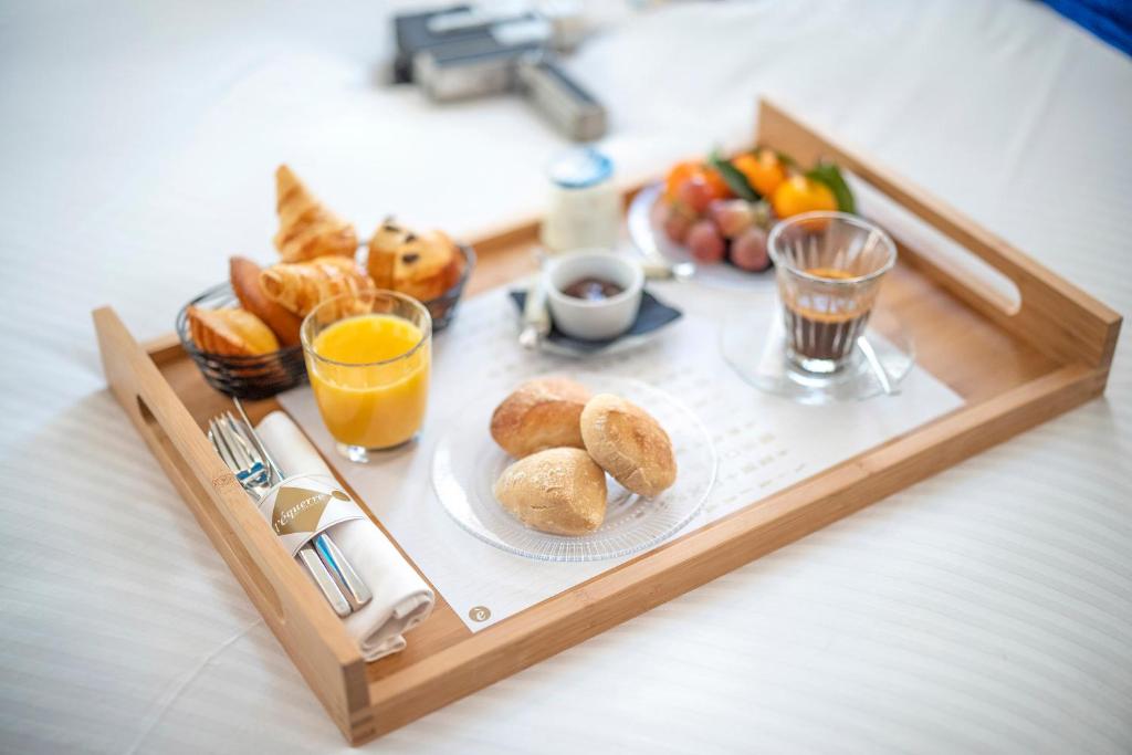 a tray with breakfast foods and drinks on a table at L'Eautel Toulon Centre Port in Toulon