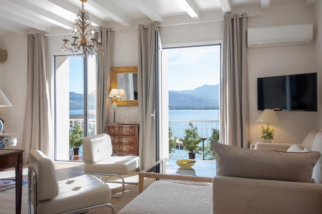 a living room with a view of the water at Le Balcon du Pêcheur in Calvi