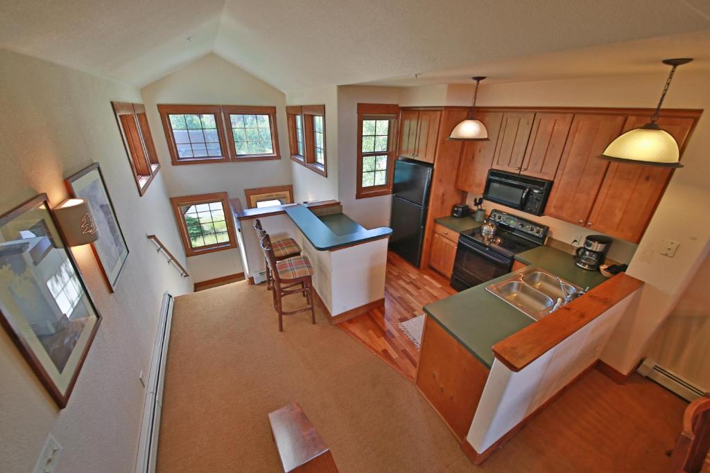 an aerial view of a kitchen and living room at Kicking Horse Lodges 4-302 in Granby