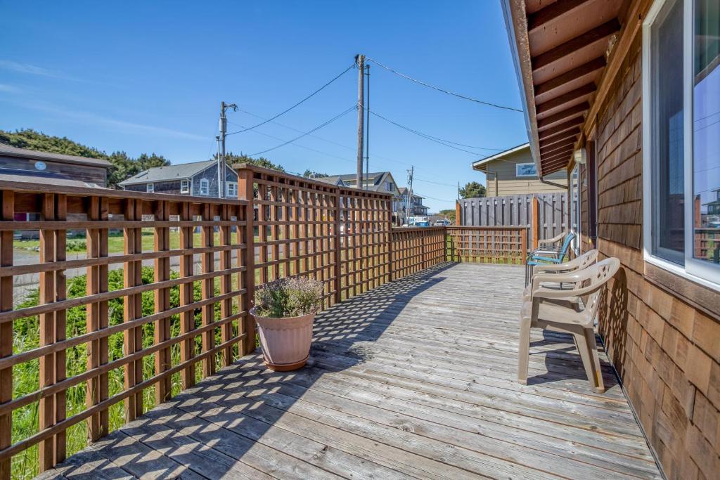 a wooden deck with a bench and a fence at Sea Gem MCA 395 - Meredith Lodging in Manzanita