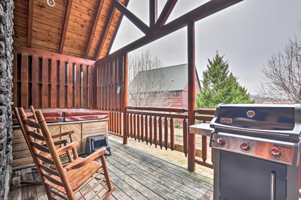 a screened in porch with a stove and a chair at Pigeon Forge Cabin with Games, 1 Mi to Parkway! in Pigeon Forge