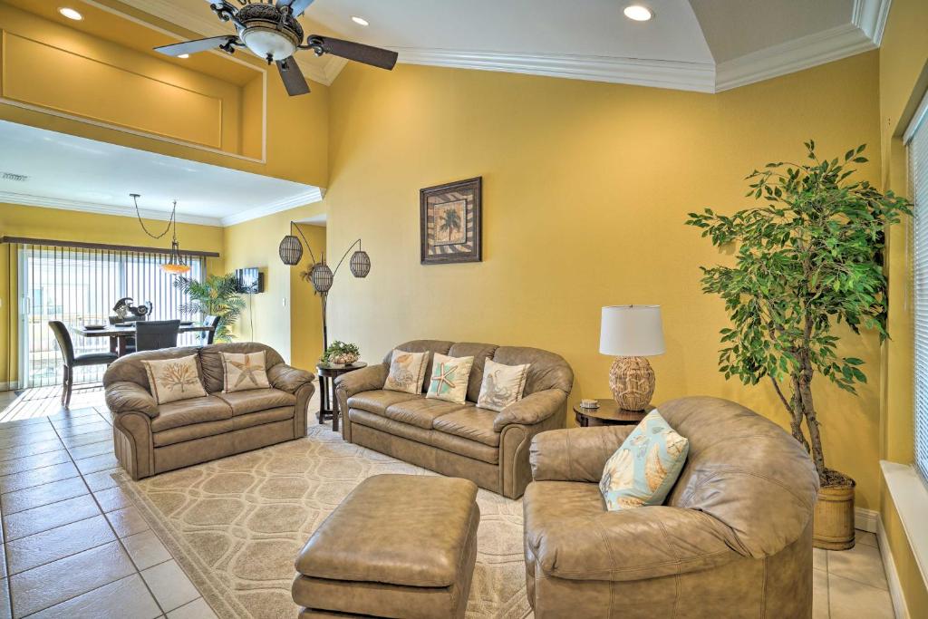 a living room with two couches and a table at Coastal Condo with Pool in South Padre Island! in South Padre Island