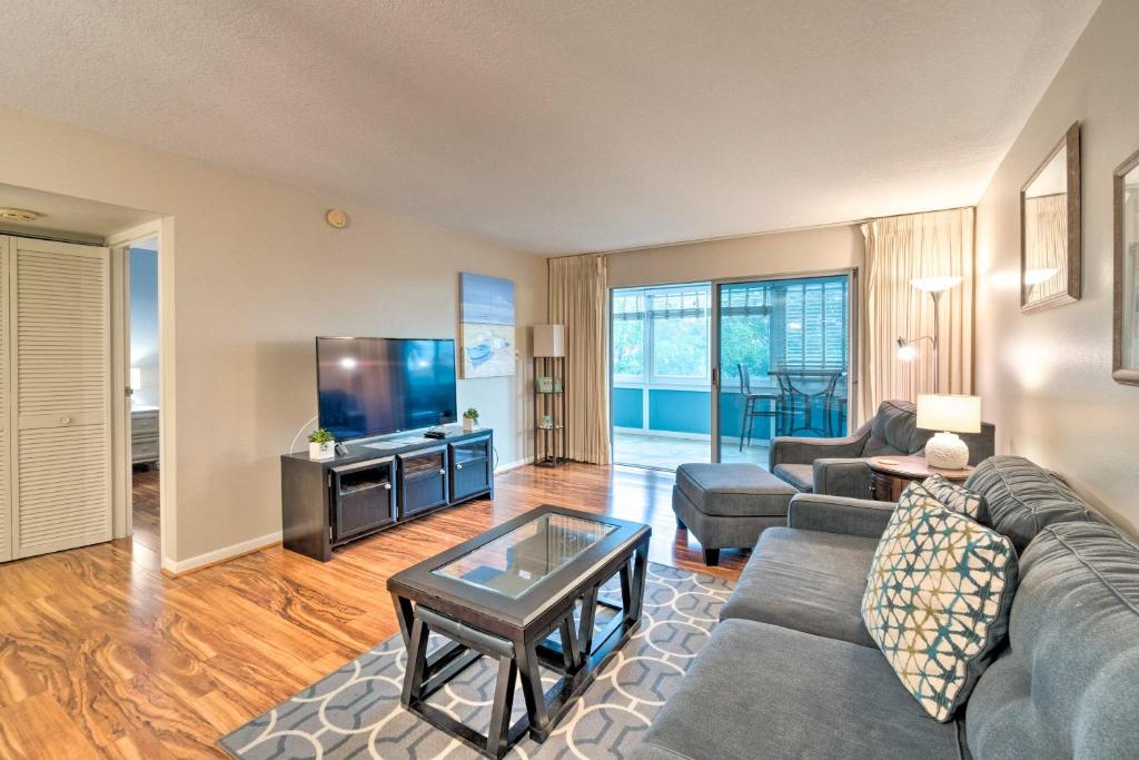 a living room with a couch and a tv at Resort-Style Siesta Key Condo Walk to Beach! in Siesta Key