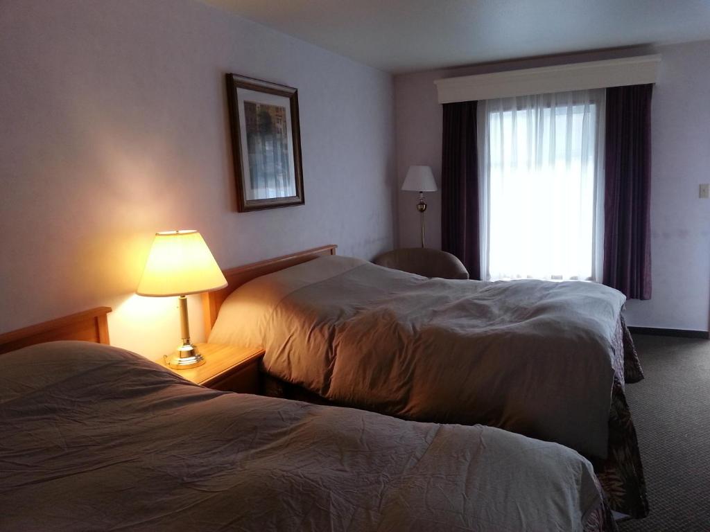 Postel nebo postele na pokoji v ubytování Heritage Inn
