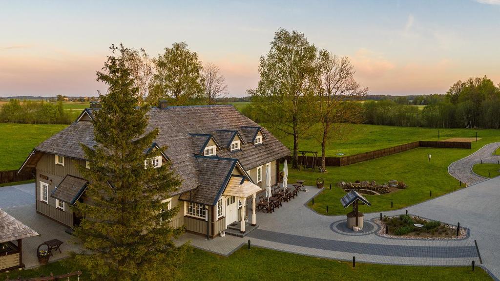 an aerial view of a large house with a yard at Kaimo turizmo sodyba "Ąžuola" in Vainutas