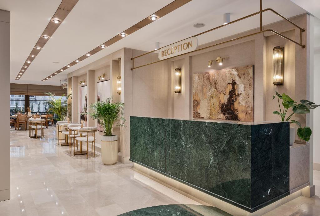 a lobby of a restaurant with tables and chairs at Delita City Hotel in Istanbul