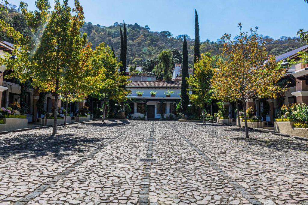 a cobblestone street in front of a house at Villa 14 Santa Ines Antigua Guatemala in Antigua Guatemala
