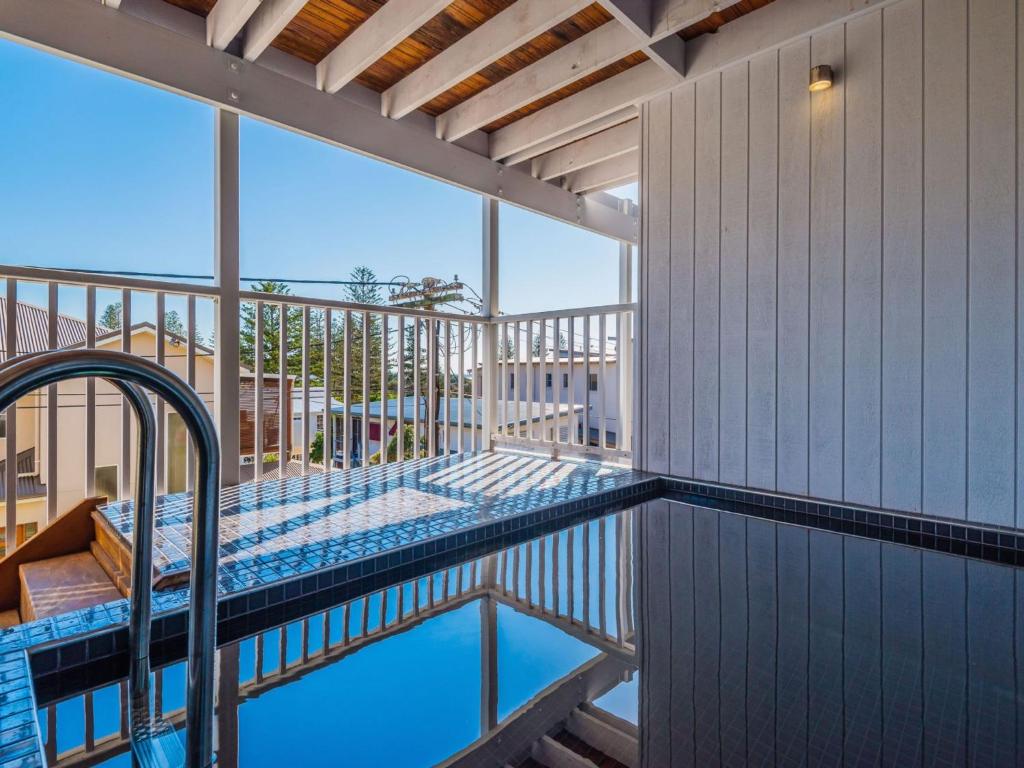 a swimming pool on the balcony of a house at SeaCrest in Yamba