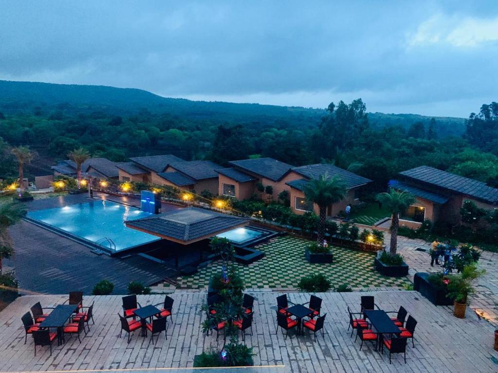 an overhead view of a swimming pool with chairs at Regenta Resort Belagavi in Belgaum
