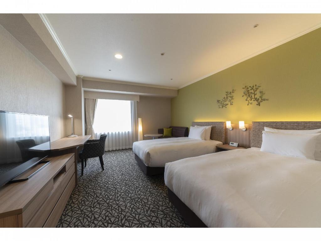Postel nebo postele na pokoji v ubytování Hotel Associa Toyohashi