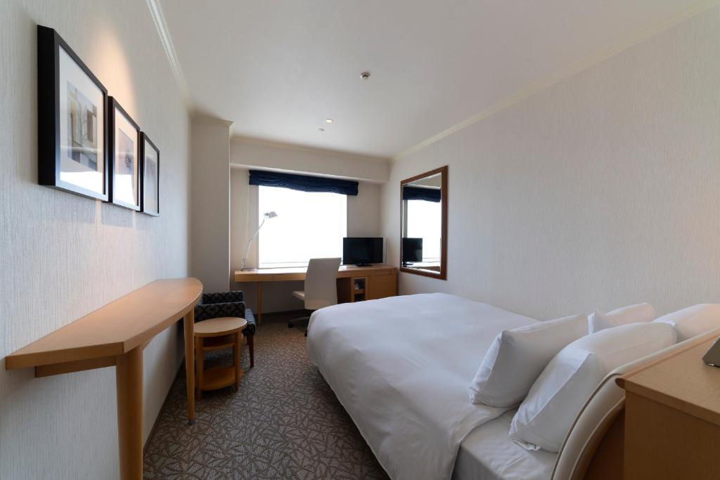 Postel nebo postele na pokoji v ubytování Hotel Associa Toyohashi