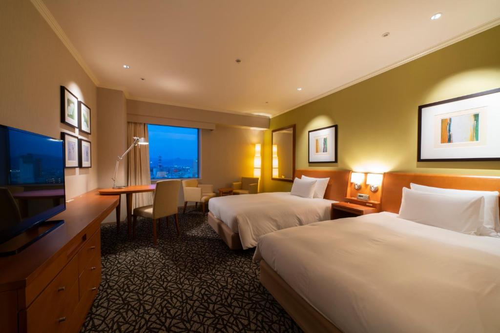 Postel nebo postele na pokoji v ubytování Hotel Associa Toyohashi