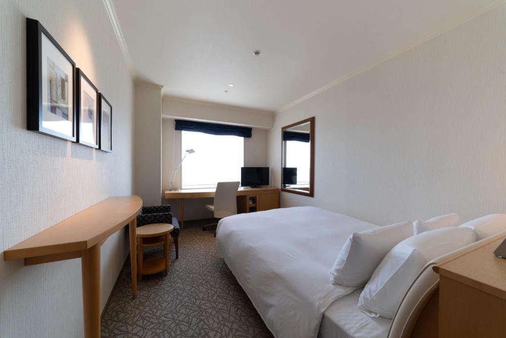 Postel nebo postele na pokoji v ubytování Hotel Associa Toyohashi