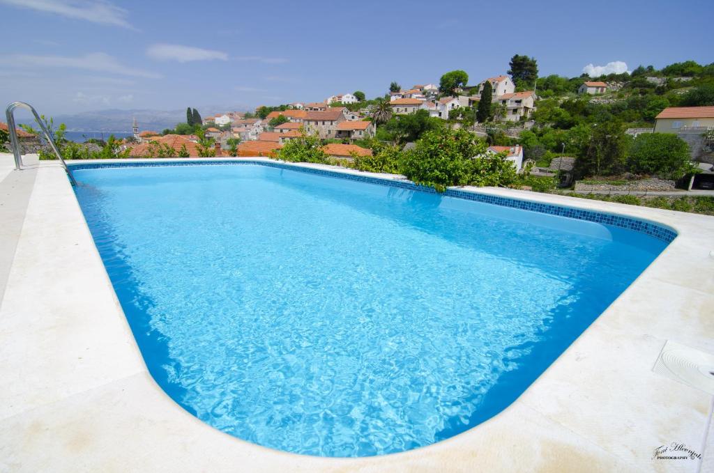 a swimming pool in a villa with a view at Villa Green Garden in Splitska