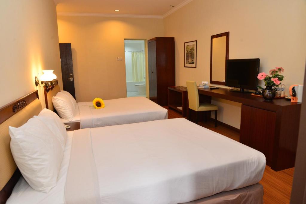 Postel nebo postele na pokoji v ubytování Cheng Ho Hotel
