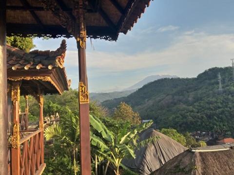 a balcony of a building with a view of a mountain at Villa Manouria - Marcel in Padangbai