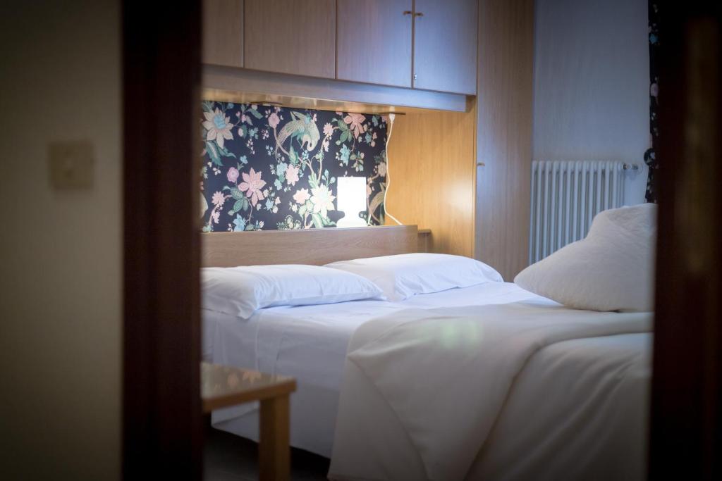 Posteľ alebo postele v izbe v ubytovaní Inn Aosta Apartments
