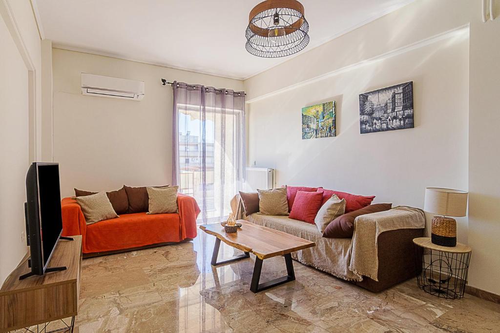 a living room with a couch and a tv at Two Bedroom Apartment in Chalandri with Balcony in Athens