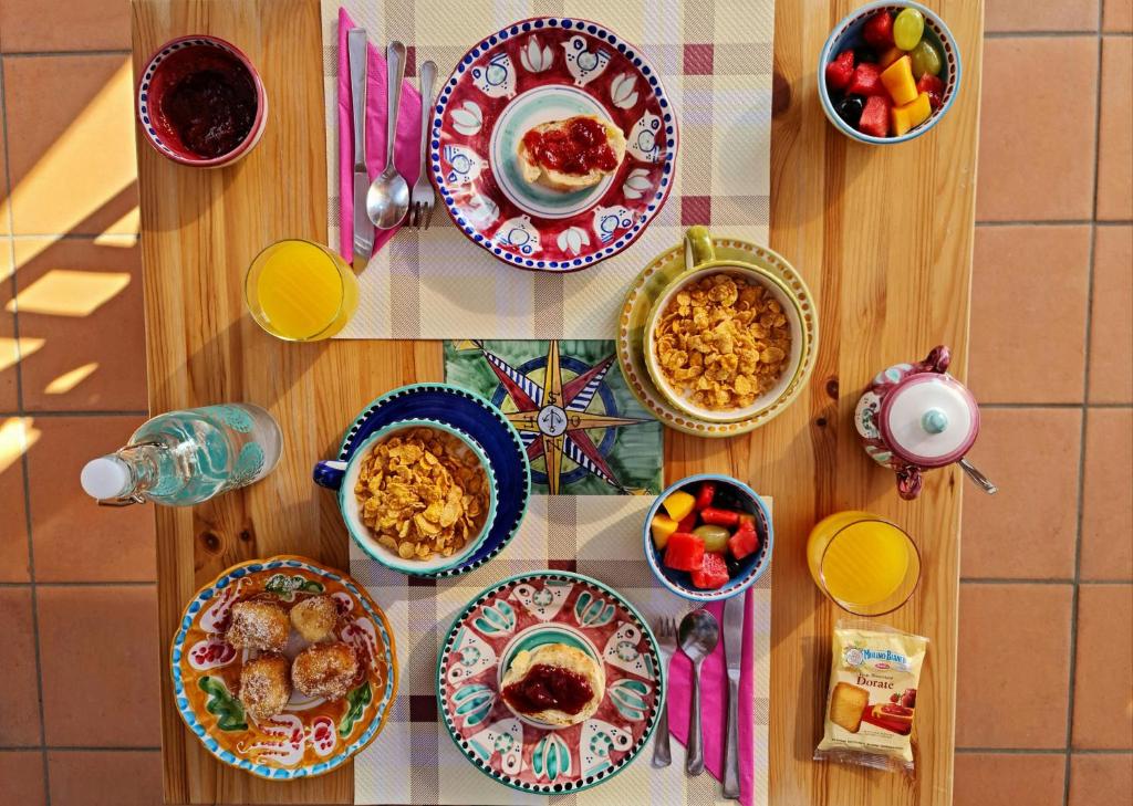 a wooden table with plates of food on it at B&b Rosaria Amalfi Coast in Vietri sul Mare