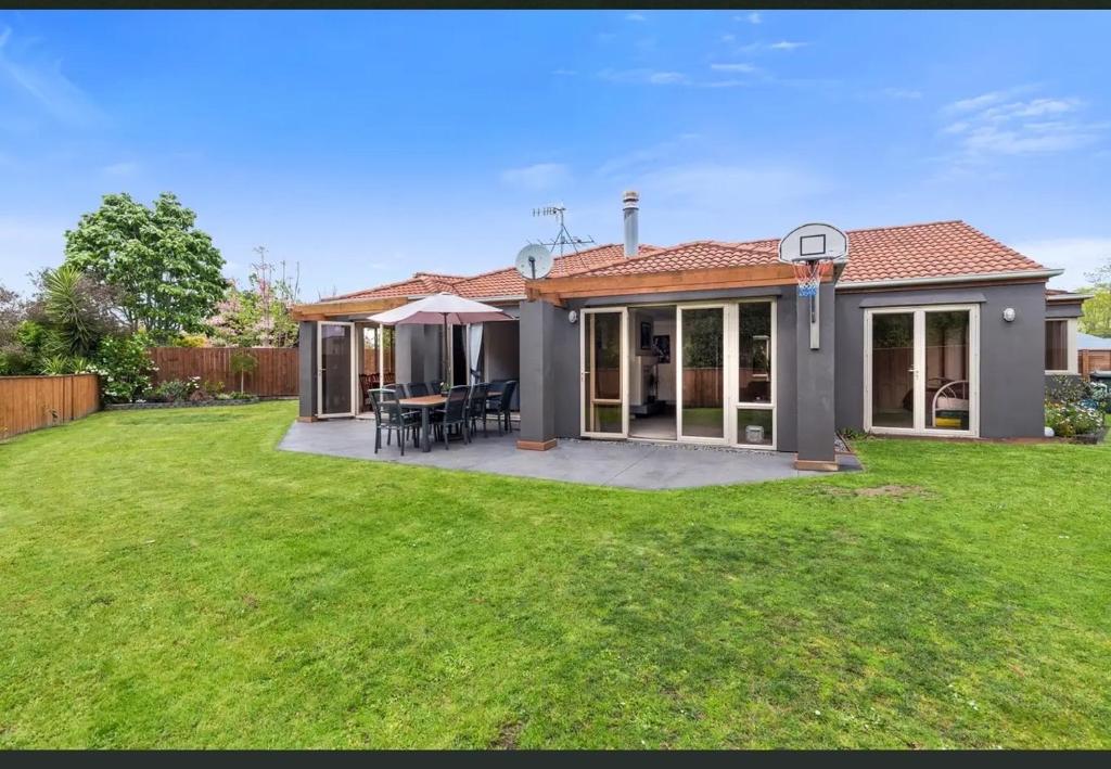a house with a patio and a grass yard at Private and Perfect for Families, Rotorua Escape in Rotorua