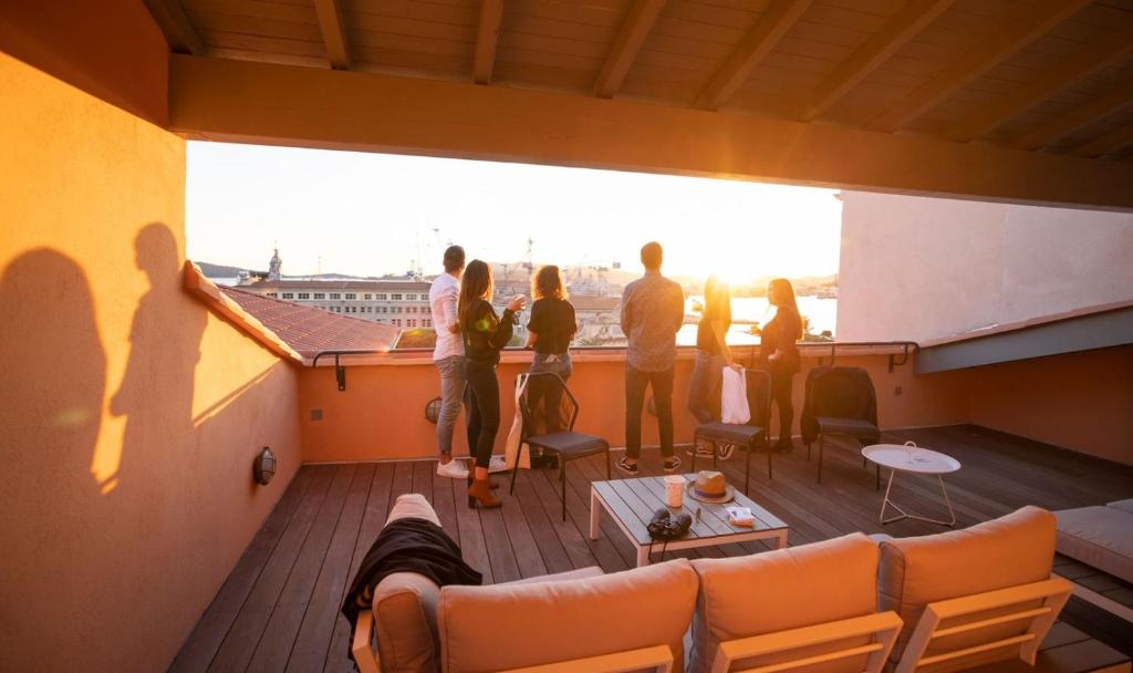 a group of people standing on the deck of a balcony at L'Eautel Toulon Centre Port in Toulon