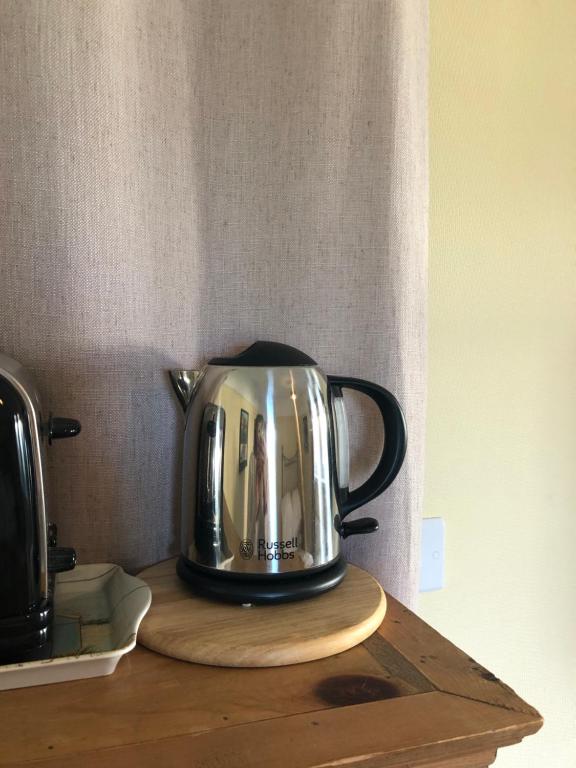 a tea kettle sitting on top of a table at The Stoep in Paignton