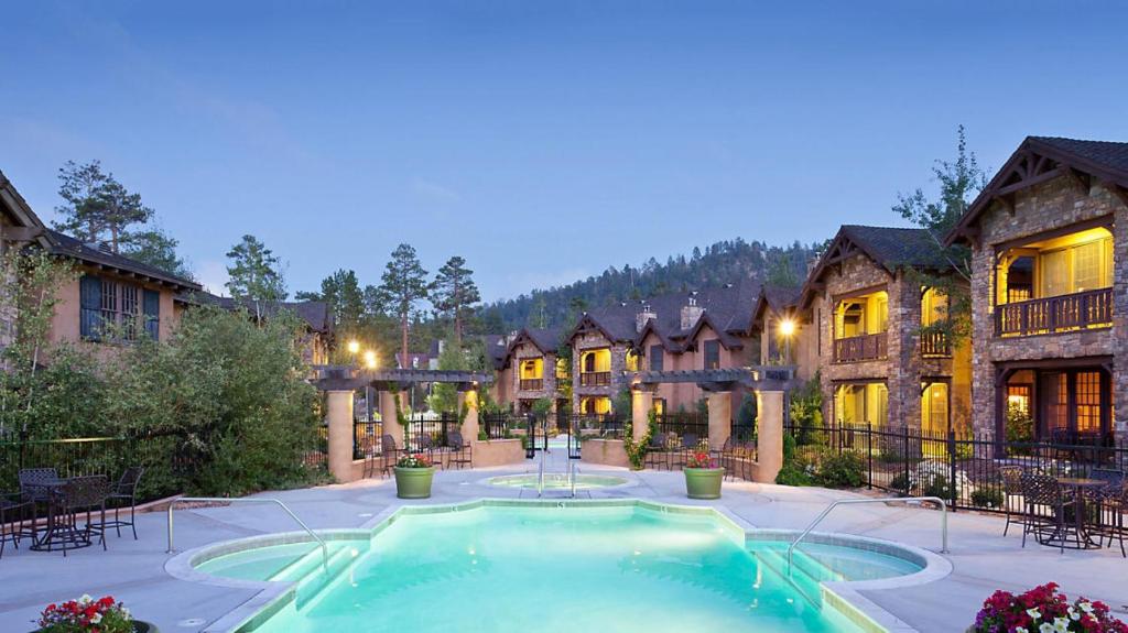 a large house with a swimming pool in the yard at Bluegreen Vacations Big Bear Village, Ascend Resort Collection in Big Bear Lake