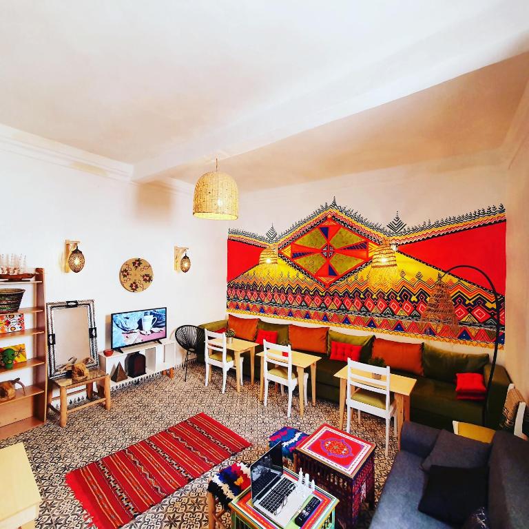 a living room with a couch and a red wall at Art house in El Jadida
