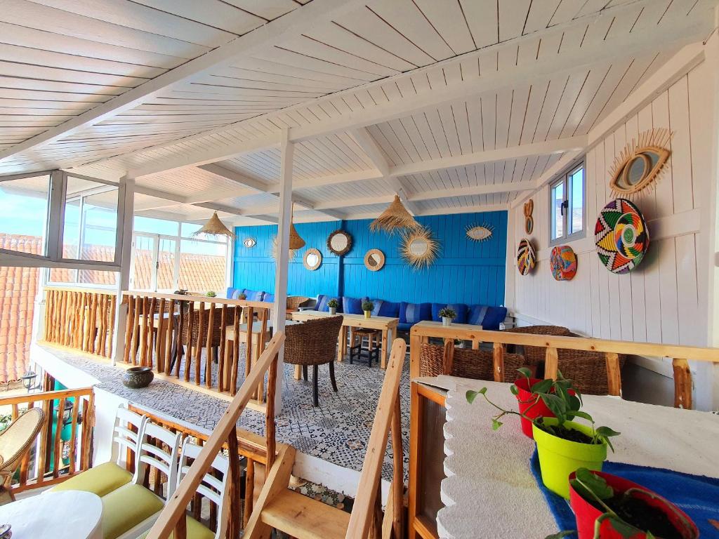 a room with blue walls and tables and chairs at Art house in El Jadida