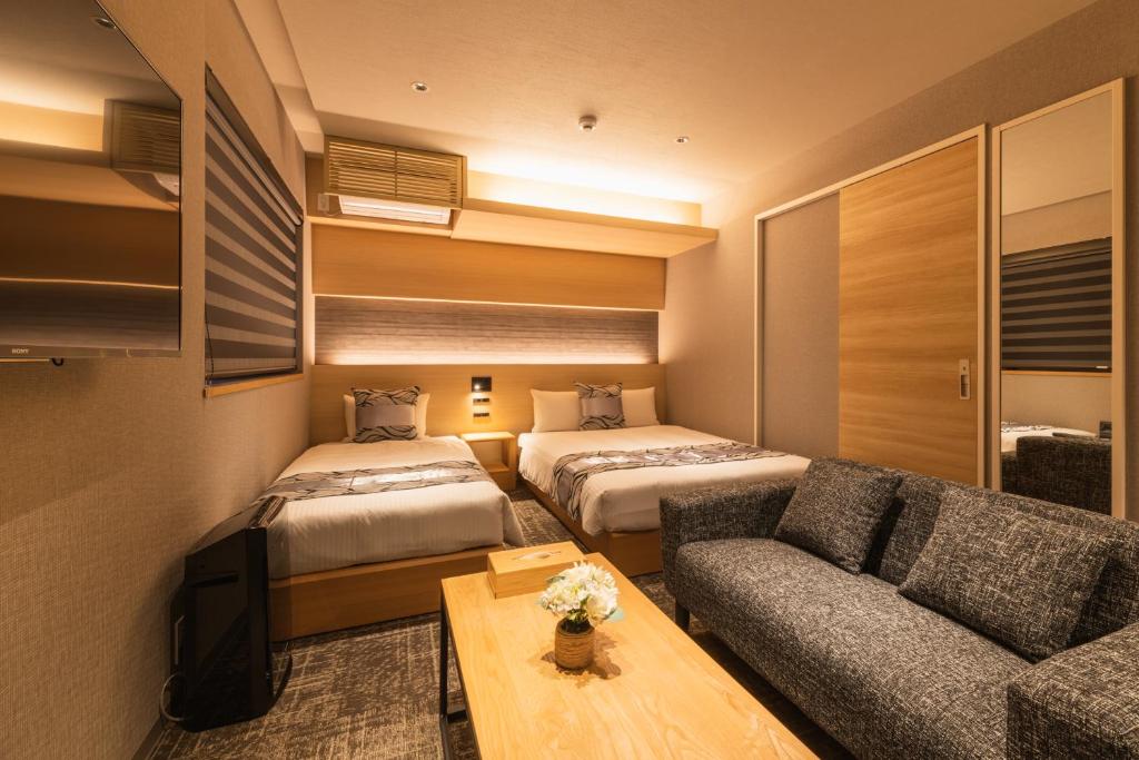 Postel nebo postele na pokoji v ubytování GRAND BASE Kagoshima Chuo