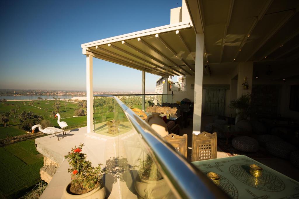 a balcony of a house with a view of a yard at Holy Family Hotel in Jabal aţ Ţayr