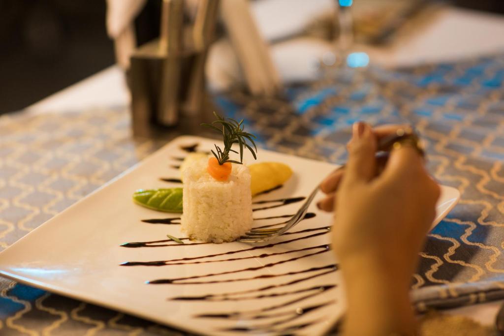 a plate with a piece of food on a table at Holy Family Hotel in Jabal aţ Ţayr