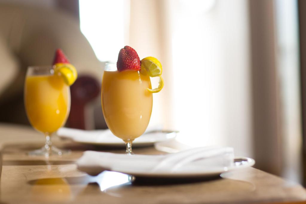 a table with two glasses of drinks on a table at Holy Family Hotel in Jabal aţ Ţayr